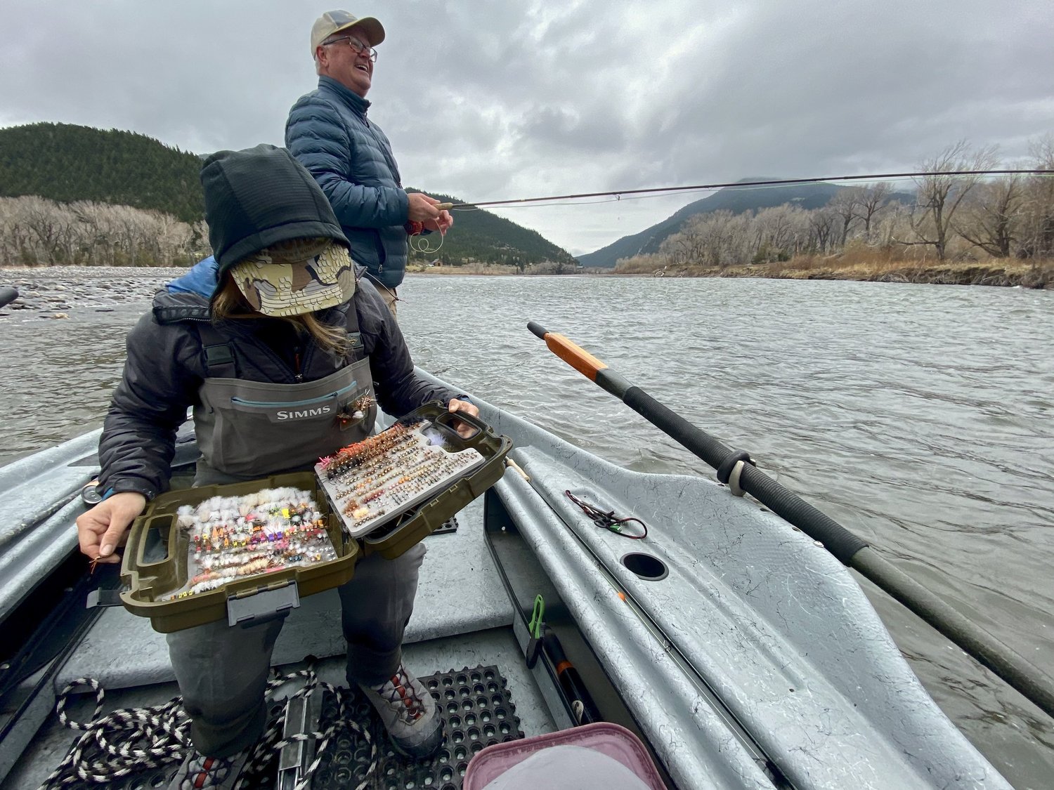 Fly fishing guide and guest on a drift boat during a Yellowstone River scenic and fishing experience near Livingston Montana.