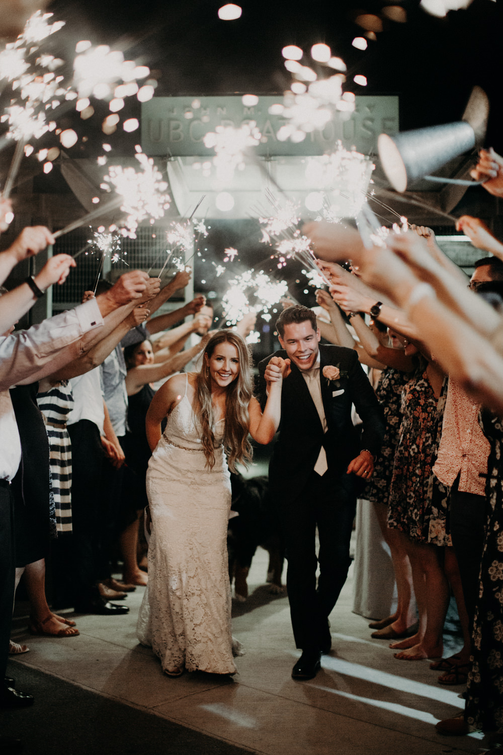 The bride and groom leaving their wedding via a sparkler exit. 