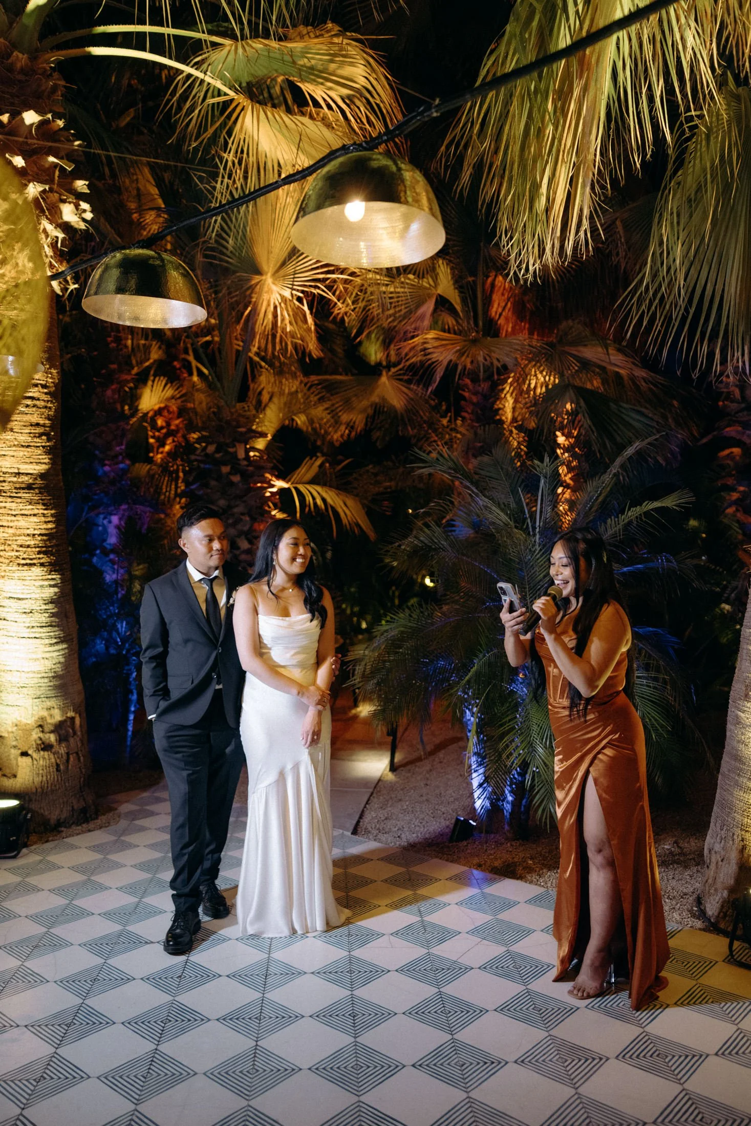A couple stands and listens to the maid of honour speech in the blue room at acre resort in cabo, mexico