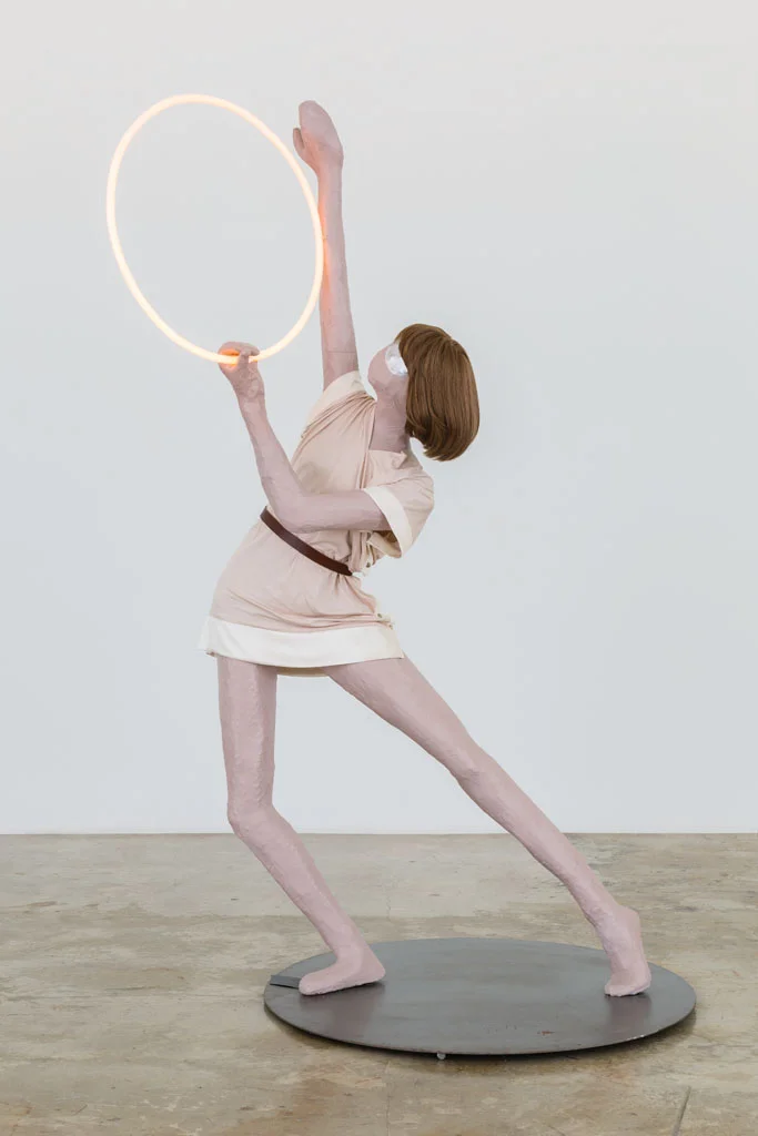 Mai-Thu Perret with Ligia Dias, Apocalypse Ballet (Pink Ring), 2006, steel, wire, papier-mâché, emulsion paint, varnish, gouache, wig, fluorescent tubes, viscose dress and leather belt (designed and made by Ligia Dias), 210 x 135 x 100 cm. Rubell Family Collection