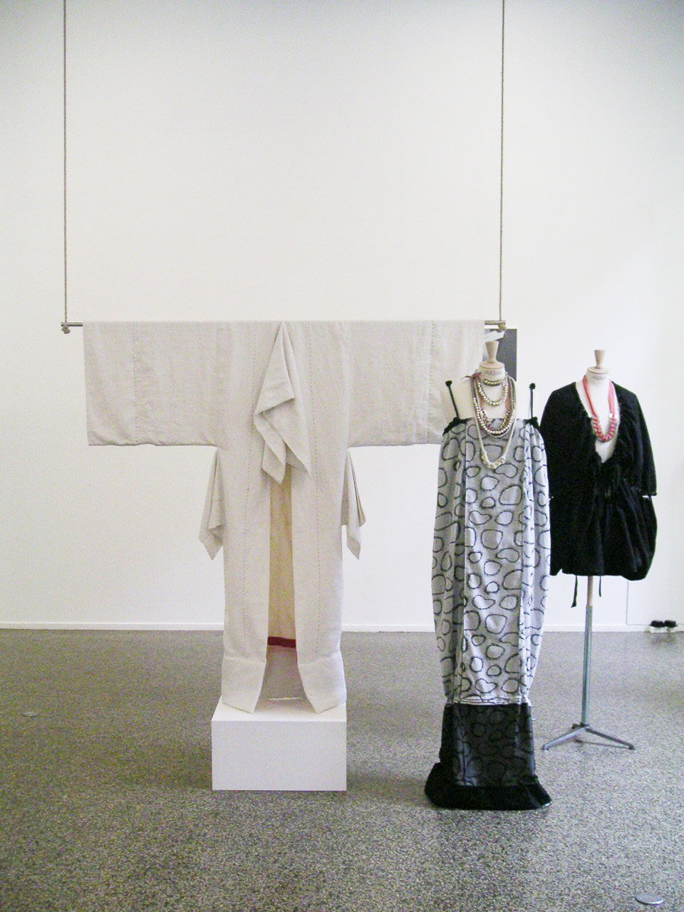 Exhibition view. Kimono (Clinique box), 2005, linen, cotton, wood, acrylic.© Ligia Dias WW, 2005, cotton, silk, original print by Genêt Mayor. © Ligia Dias Daisuke, 2005, cotton, silk, jute. © Ligia Dias Necklaces by Ligia Dias. © Ligia Dias