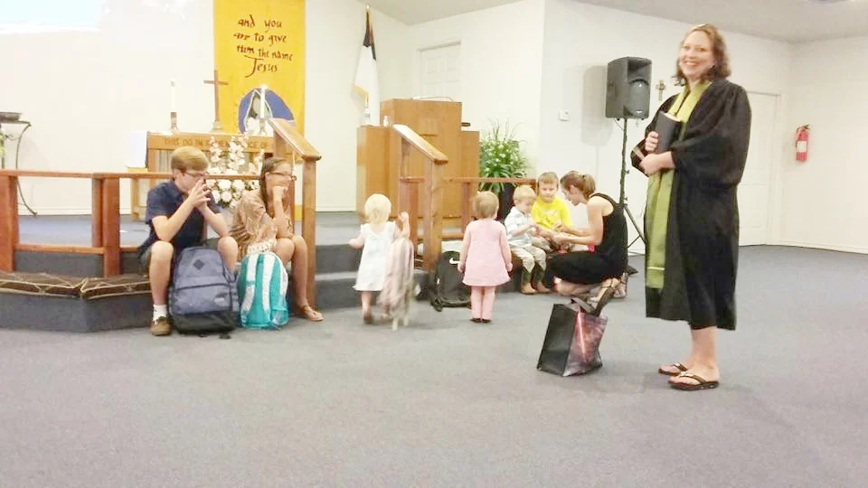 Rev. Donna Shaw leads blessing of the backpacks at Granite Shoals, Grace UMC