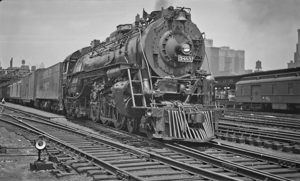 On July 6, 1948, locomotive 3463 stands ready to haul its next train out of Dearborn station in Chicago. Already the locomotive has been modified by the ATSF: the boiler check valves have been moved to the top of the boiler and the whistle has been moved to the front of the locomotive. Image from the collection of Warren M. Scholl, photographer unknown.