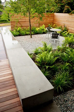 concrete and wood against gravel and planting
