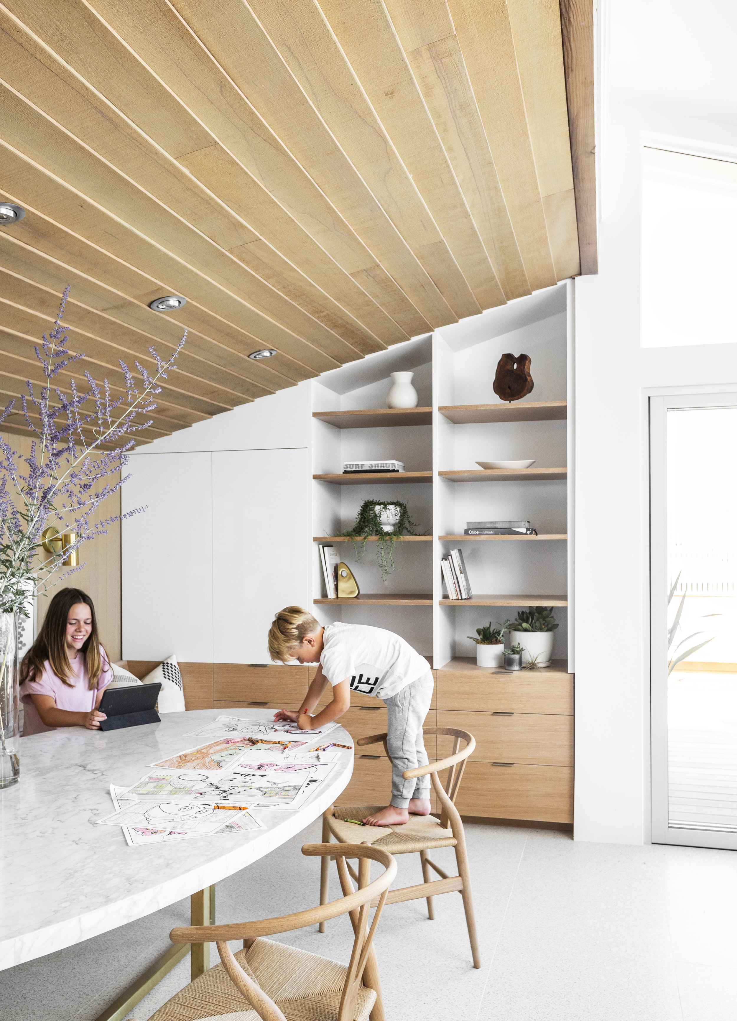 A kitchen nook has built in seating and storage for a casual zone where the children do homework and projects in close proximity to the kitchen and dining room.