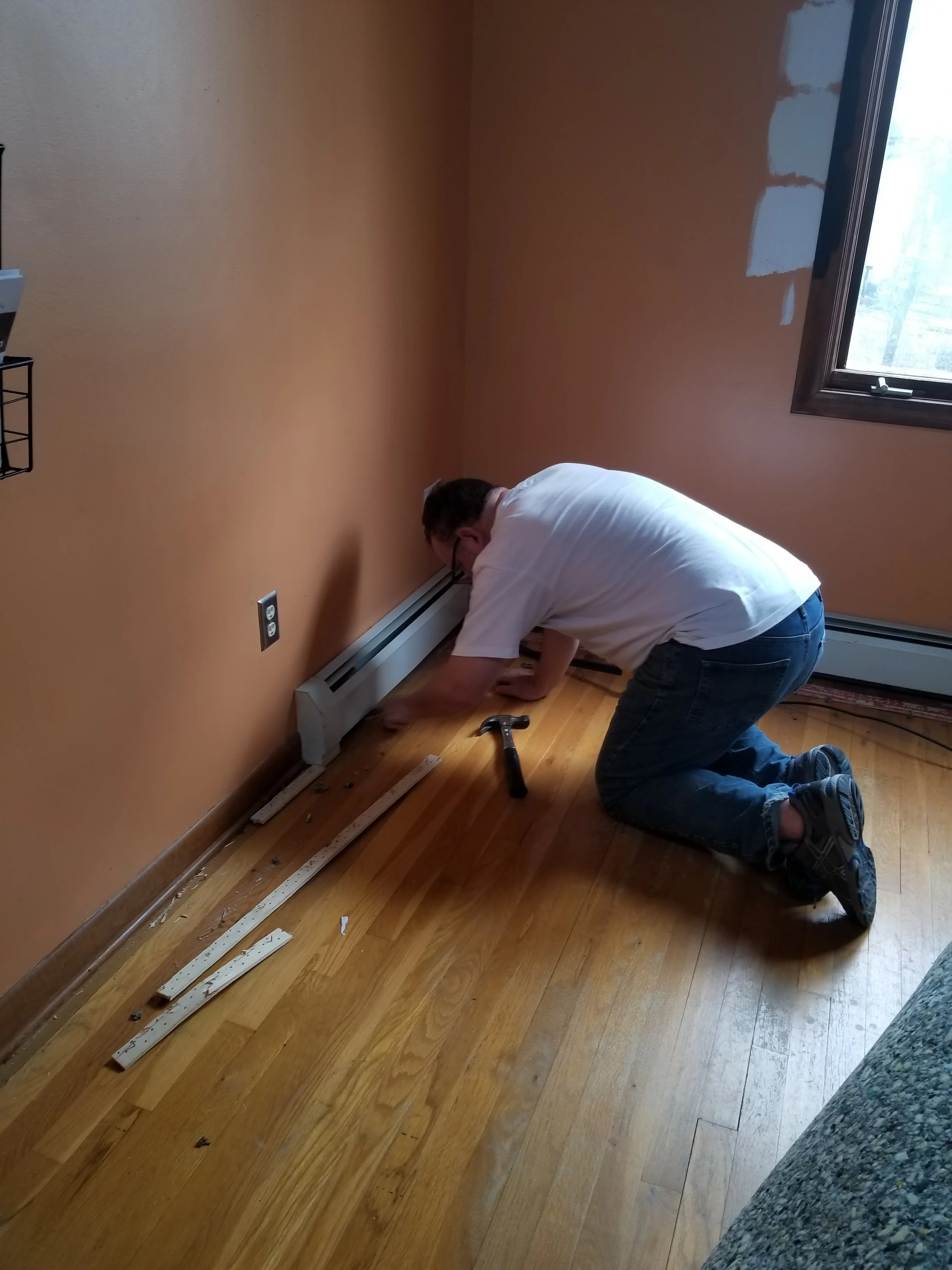 That's my willing victim...I mean husband, helping me tear up the carpet.