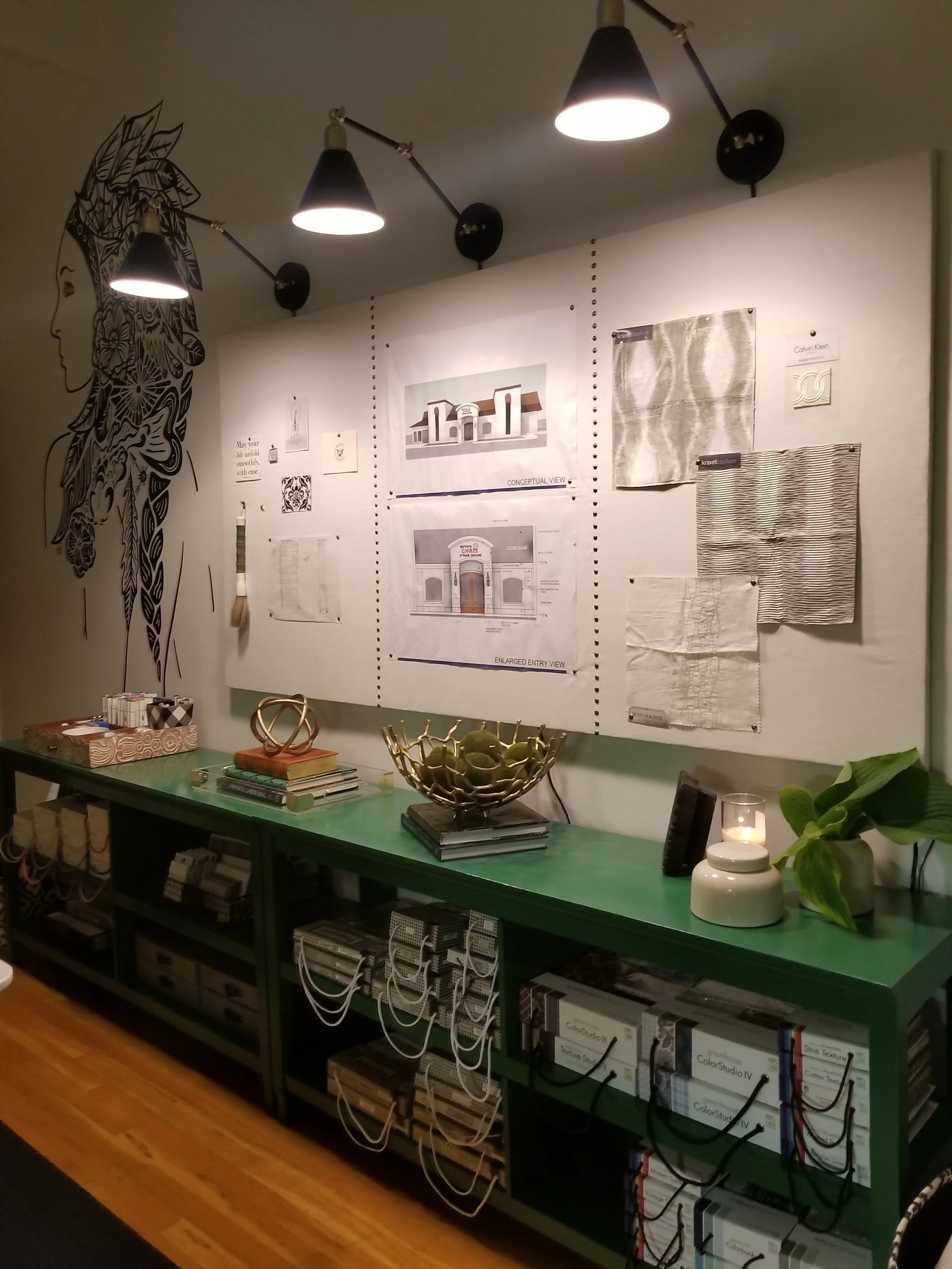 The green shelves are very useful lined up underneath the inspiration/cork board with lights. The board also hides the cords, because they are plug ins.