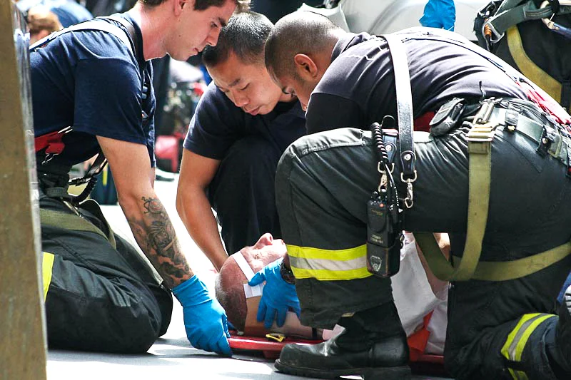Paramedics responding to an Sorel Depas-Medina, 70, after an SUV that jumped the curbed and pinned him against the wall on Broad Street, New York City, August 24, 2012.