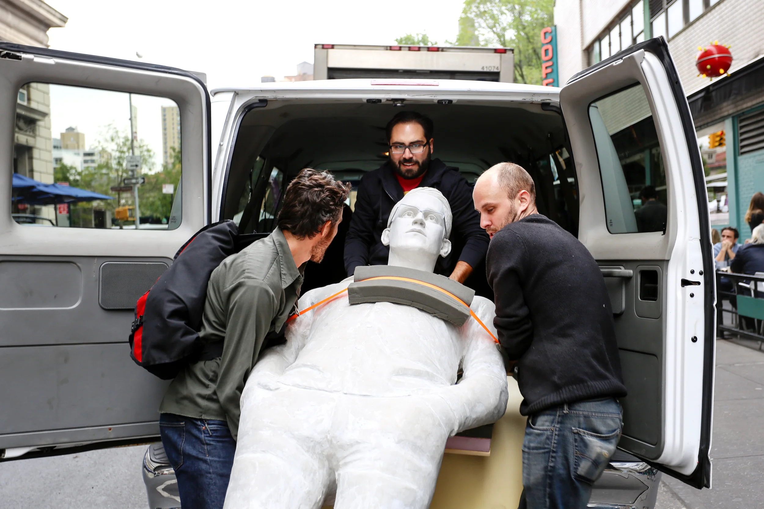 Artist Jim Dessicino, center, hauling his 9-foot tall sculpture of Edward Snowden into his van after officials ordered that he remove the statue from Union Square for failing to provide a permit, New York City, October 10, 2014.