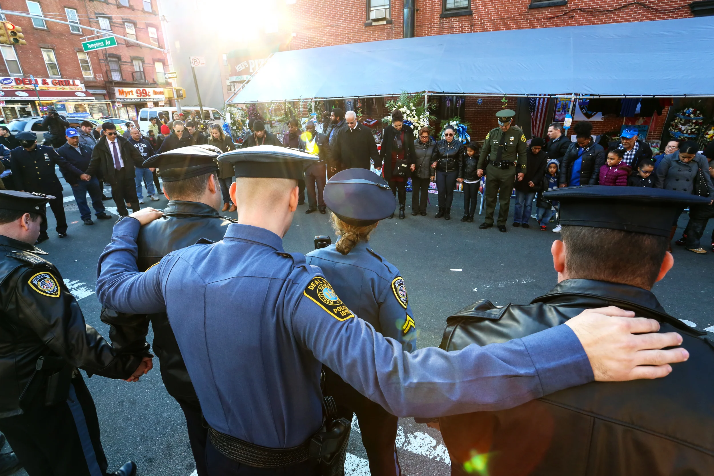NYPD officers gather in a circle in memory for two fallen NYPD officers, who were shot point blank in their police cruiser, in Bed Stuy, Brooklyn, New York.