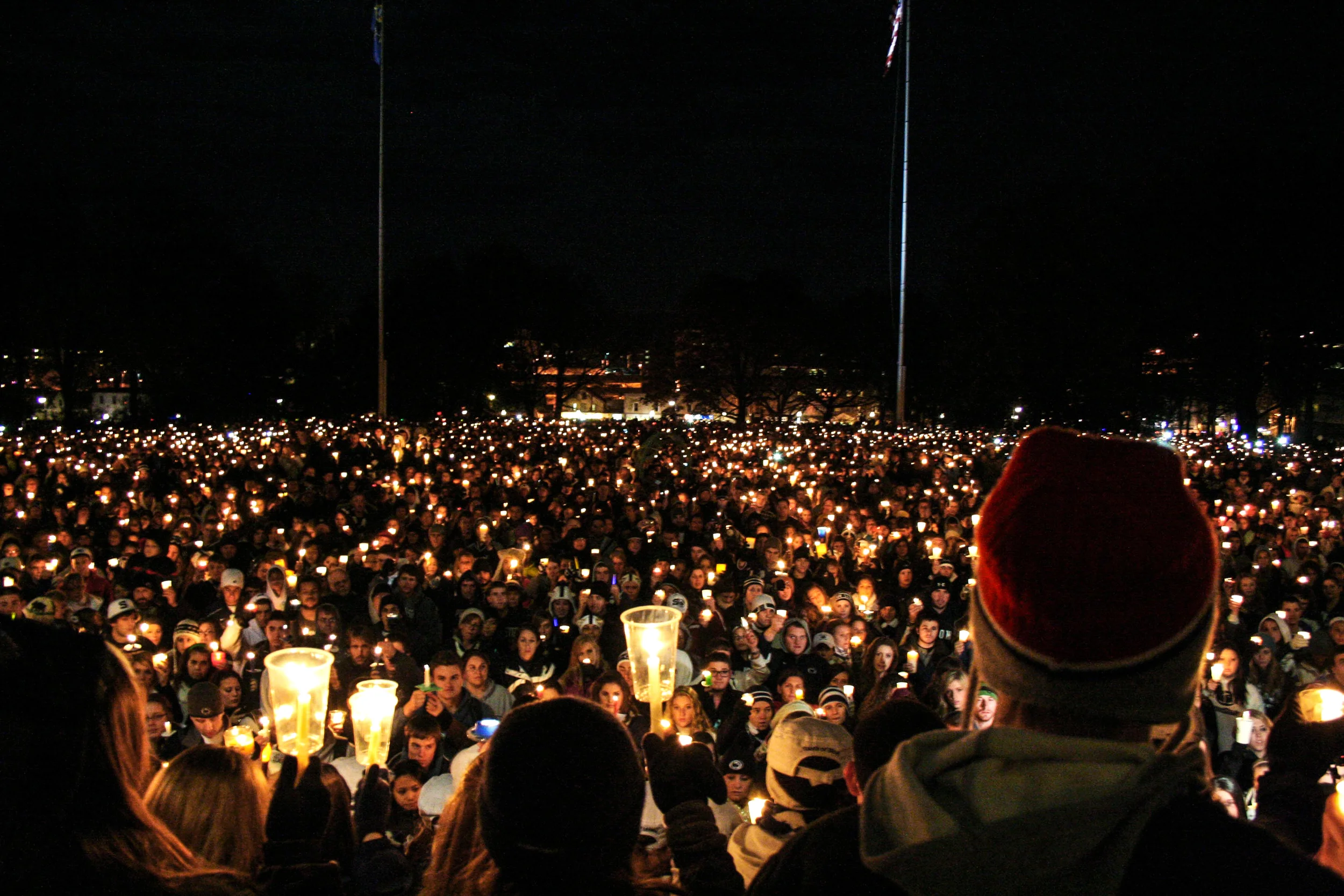People gather in front of the Old Main building for a candlelight vigil on the Penn State campus for the alleged victims of Jerry Sandusky, State College, PA, November 12, 2011.