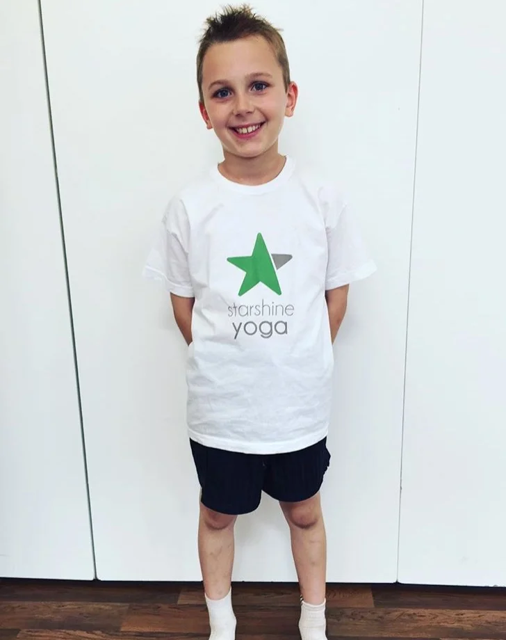 Max receiving his celebratory yoga t shirt having attended for 2 years!!