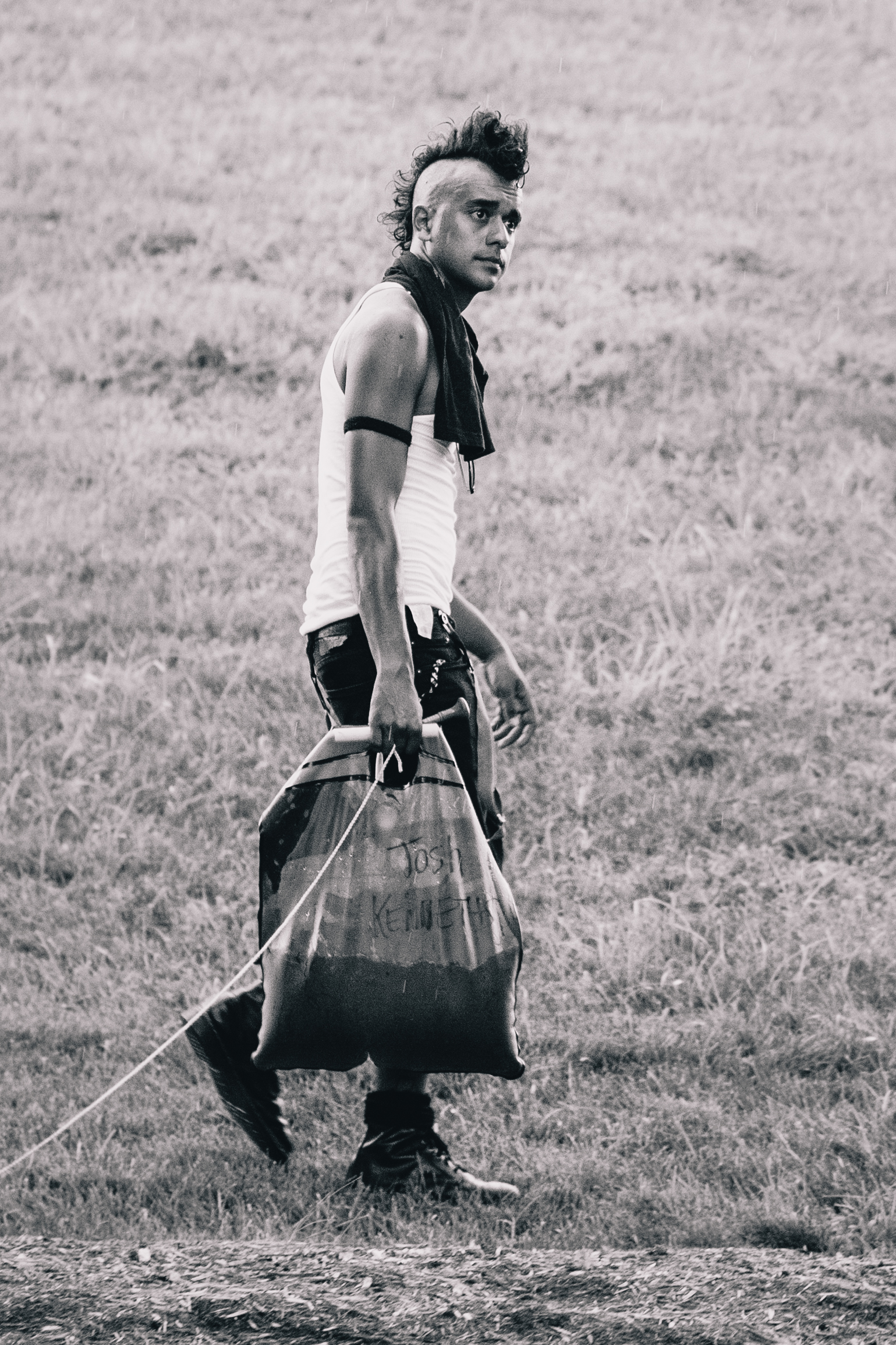 I was playing with Garland's telephoto lens shooting pictures of people passing the merch and sniped Josh from The Kenneths heading somewhere with his solar shower. These are essentially big plastic bladders that you fill with water and leave in the sun for a couple hours which heats up the water. You then hang this thing on a fence or your van and use the little sprocket to take a shower. I had one and it was pretty handy when there was no real shower in sight.