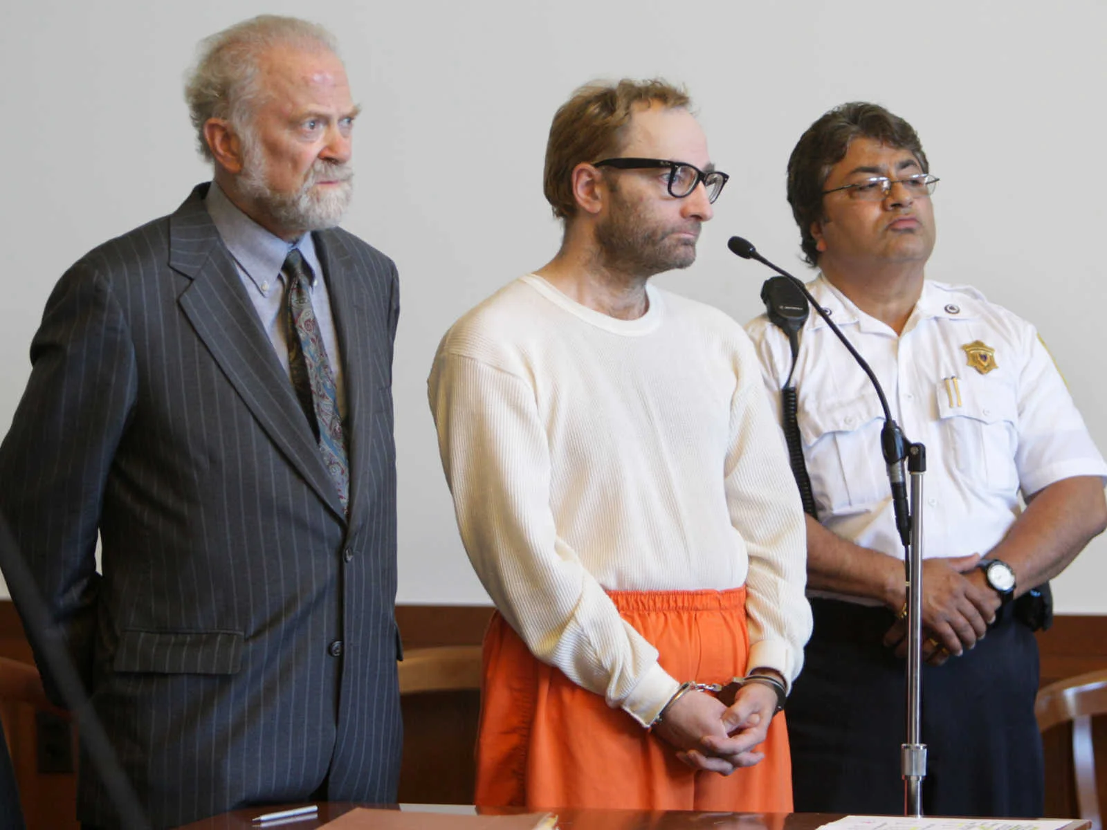 Christian Karl Gerhartsreiter,center, originally from Germany and who calls himself Clark Rockefeller, appears in municipal court for a pre-trial hearing in Boston Wednesday, Sept. 3, 2008, flanked by his lawyer Stephen Hrones, left, and an unidentified court officer, right. Gerhartsreiter has been charged with kidnapping his 7-year-old daughter in late July. (AP Photo/Mark Garfinkel, Pool)