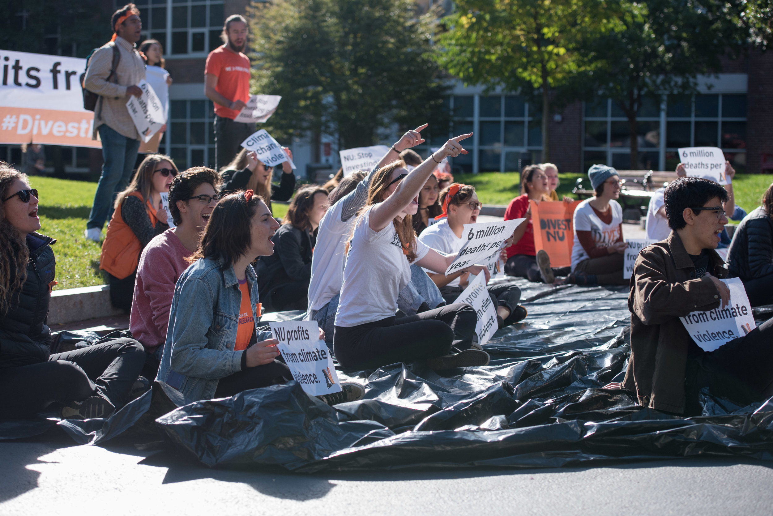  DivestNU members chant at passing prospective student groups on Saturday, Oct. 15, 2016.  "Climate change is violent, so is Northeastern's refusal to divest," the students said. 