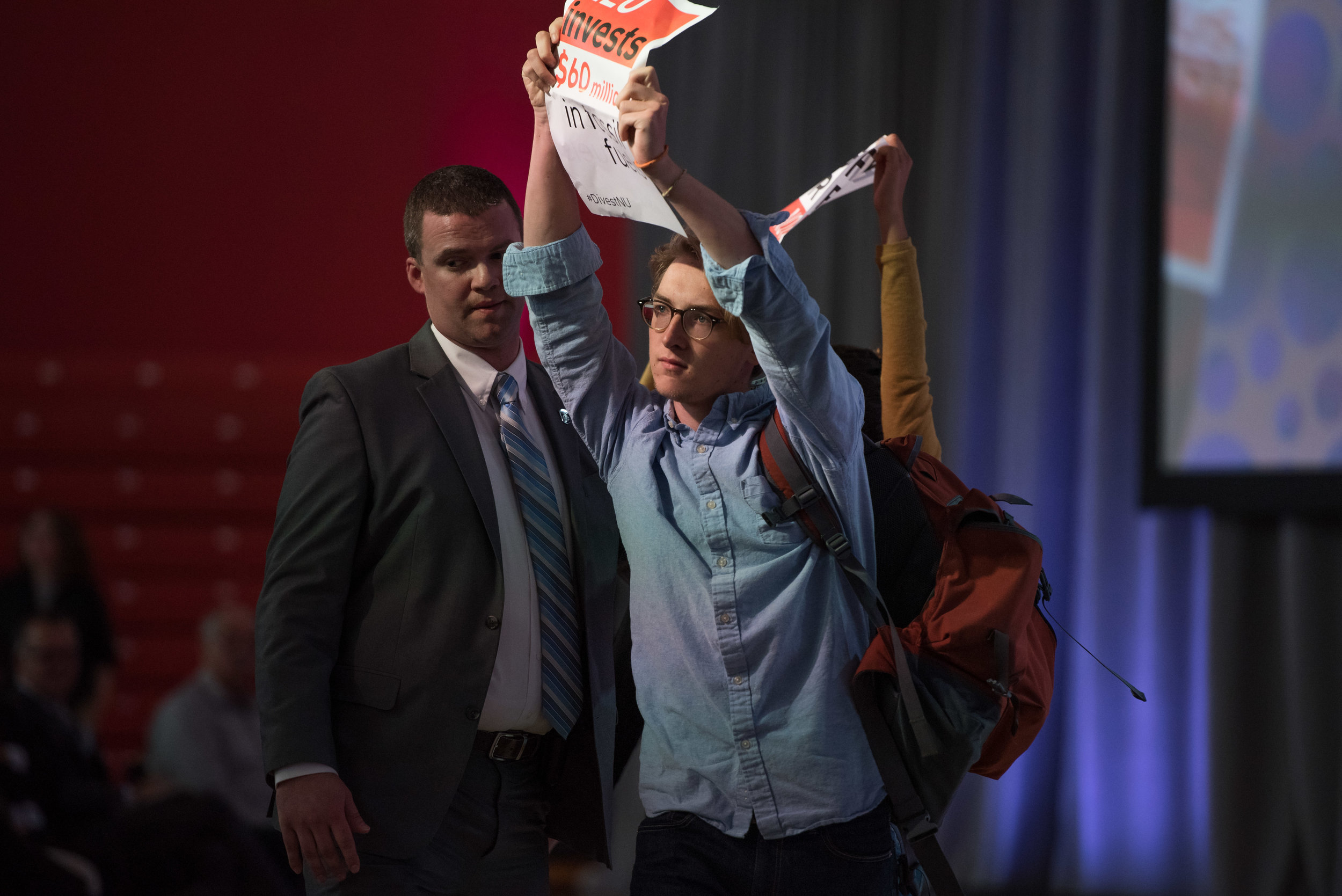  DIvestNU members James DeCunzo, in view, and Nebai Hernandez are escorted by security back to the audience after attempting to obscure camera views of the 2016 State of the University stage in Cabot Center on Thursday, Oct. 20.  "I knew security wou
