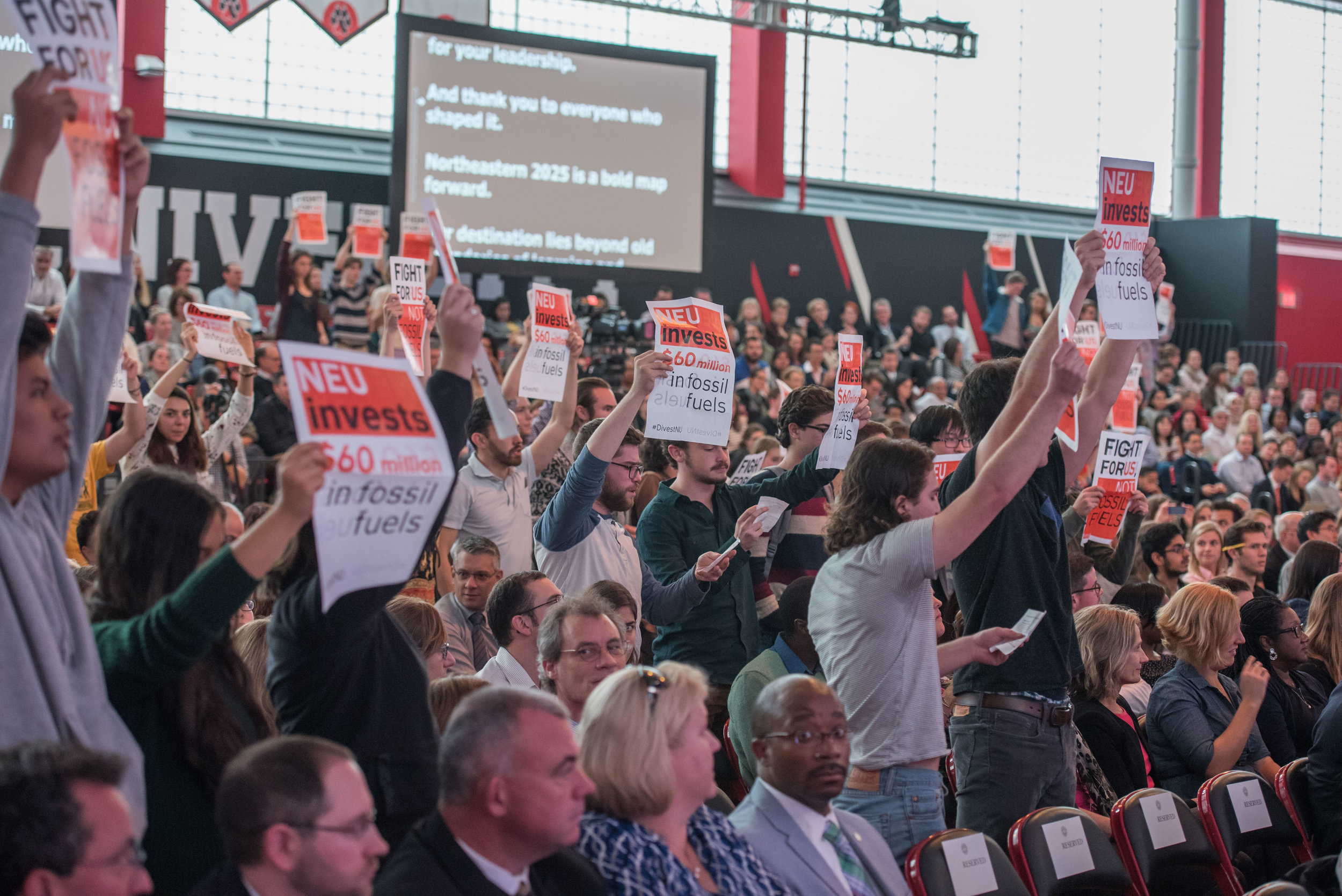  DivestNU members disrupt the 2016 State of the University on Thursday, Oct. 20.  "Today you will tell us that Northeastern is a leader in sustainability, while you continue funding climate change," the students chanted. 