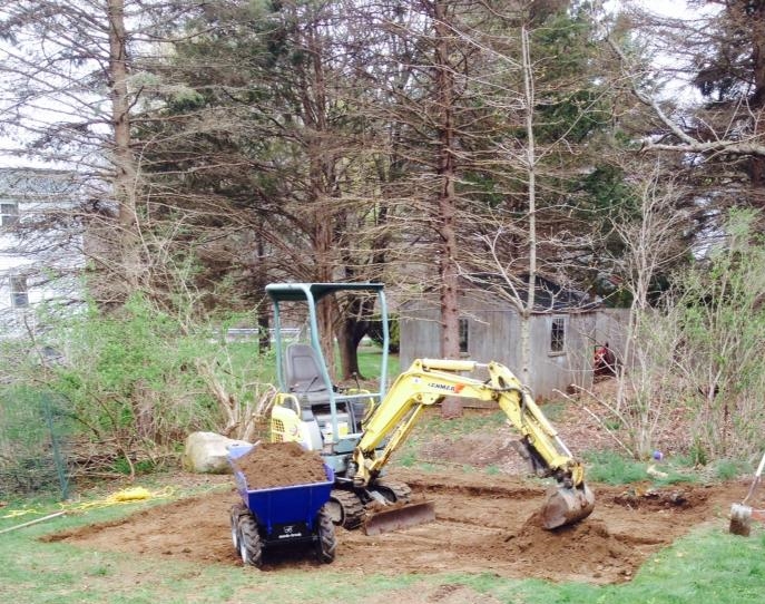 Excavator digging shed foundation