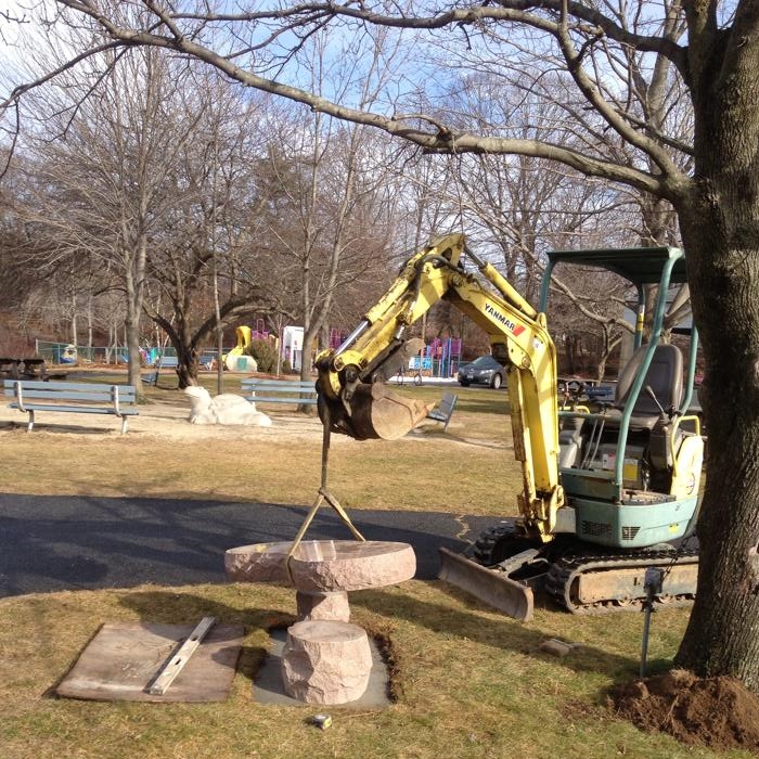 Excavator Setting Granite Bench