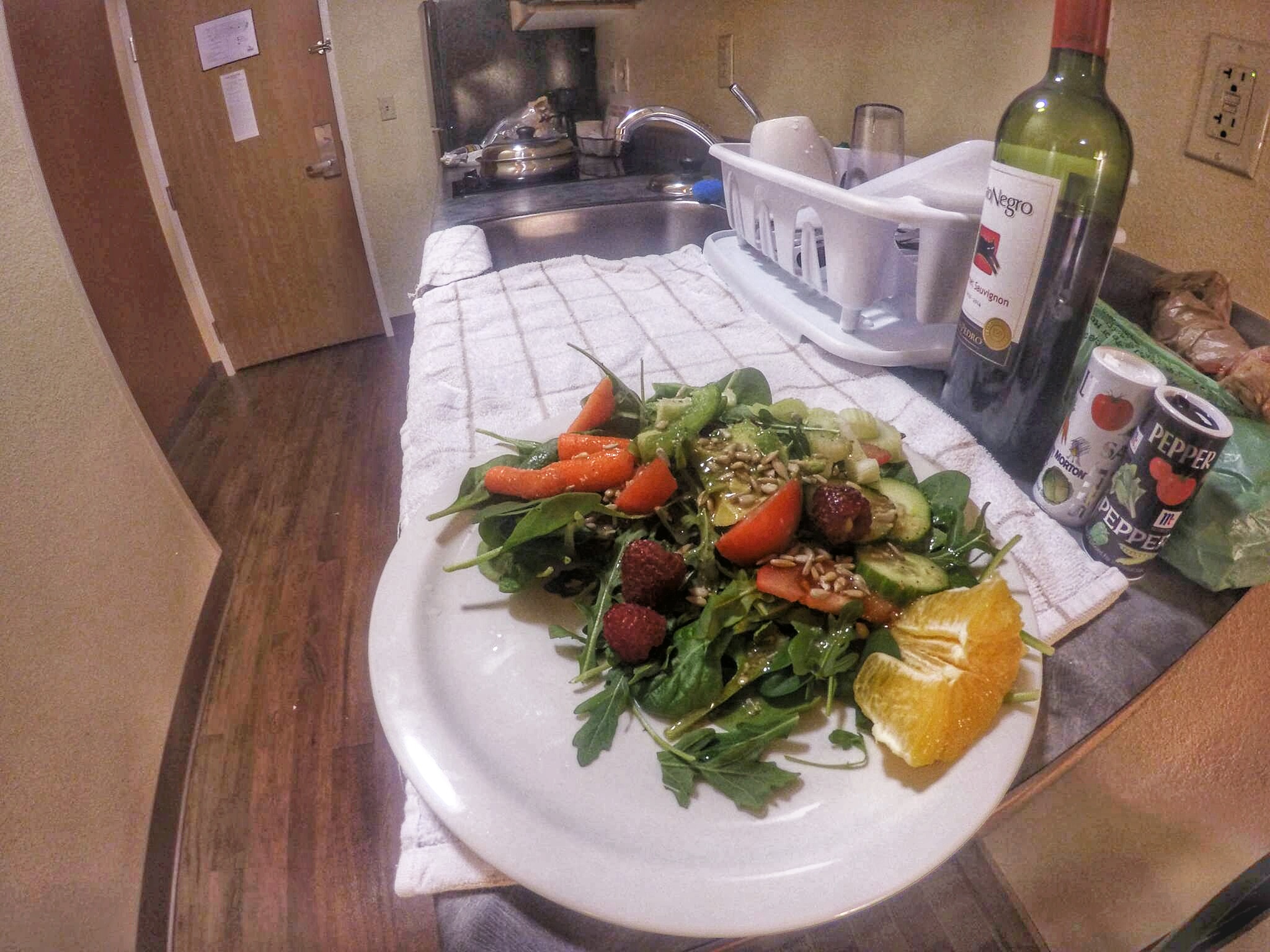 This is a pic from our hotel room in Juneau, AK. In this case, we were lucky enough to have a kitchen with stovetop and a full-size fridge. Side salad is prepped while the main dish is cooking.