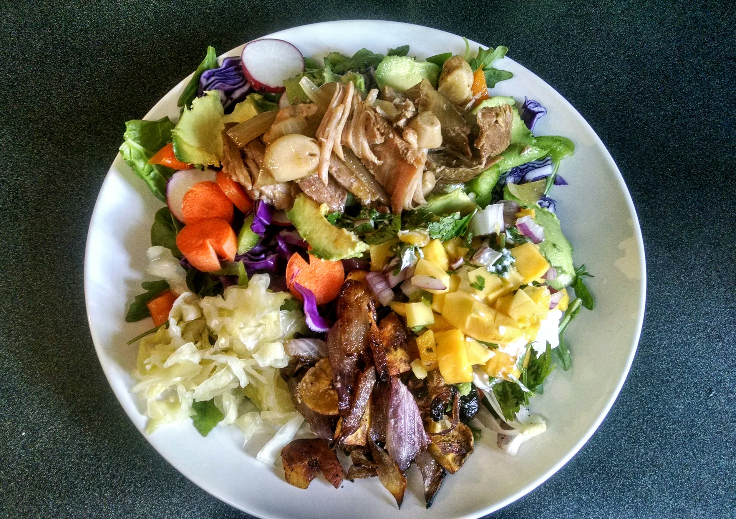 Dinner served as a large green salad (spinach & arugula) consisting of purple cabbage, carrots, green & orange bell pepper, radish, avocado, cherry tomatoes, and topped w/ pulled pork, mango salsa, sour cream, tomatillo salsa and a side of plantain chips sautéed w/ garlic and onion and a side of sauerkraut. YUM!!!