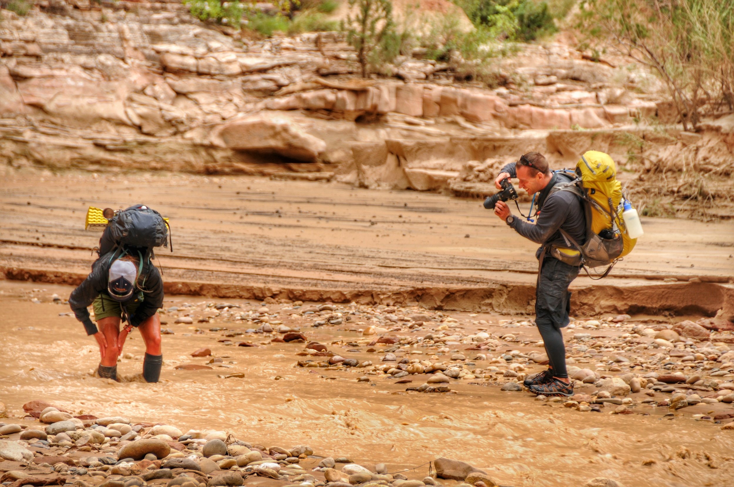 Cleaning off the mud with some muddy water :) (Tom is always looking for a great photo op)