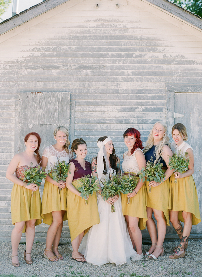 MAGNOLIA ROUGE - REAL WEDDING Canadian Backyard wedding by Brittany Mahood Photographer | Brittany Mahood Photography , Cake | Tall Grass Prairie Bakery , Florist | Fache Floral Designs Ceremony Venue | Family Residence, Bride’s Gown | Vera Wang White, Shoes| Handmade Moccasins Jewellery | Locket from Brooke Elissa , Hair | friend of the bride, Make-up | Makeup Expressions by Rimpal Bridesmaids Dresses | skirts from Ashley NEF , Grooms Attire | Custom Suit by EPH Apparel , Caterer | Modern Taco Company