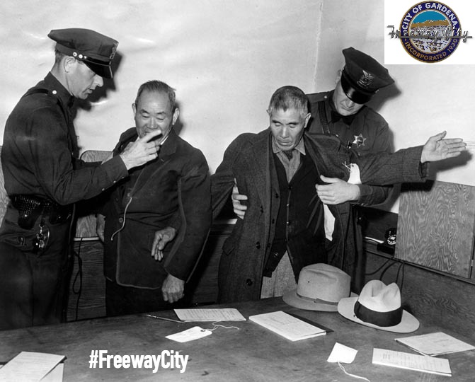TWO JAPANESE AMERICAN RESIDENTS OF GARDENA BEING TAKEN INTO CUSTODY IN GIANT ROUNDUP STAGED BY FEDERAL AGENTS (1942)