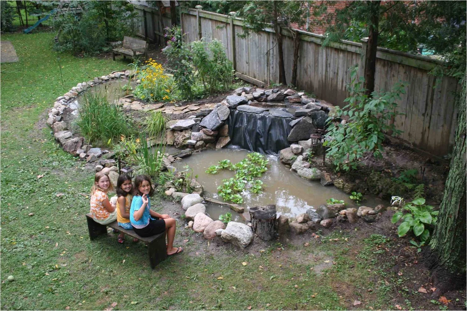 A backyard wetland system (this photo shows final stages before completion) was created in our yard, featuring two ponds (one deep with fish, the other shallow for dragonflies), a main waterfall, a spillway and 'marsh filter' were installed. The wil…