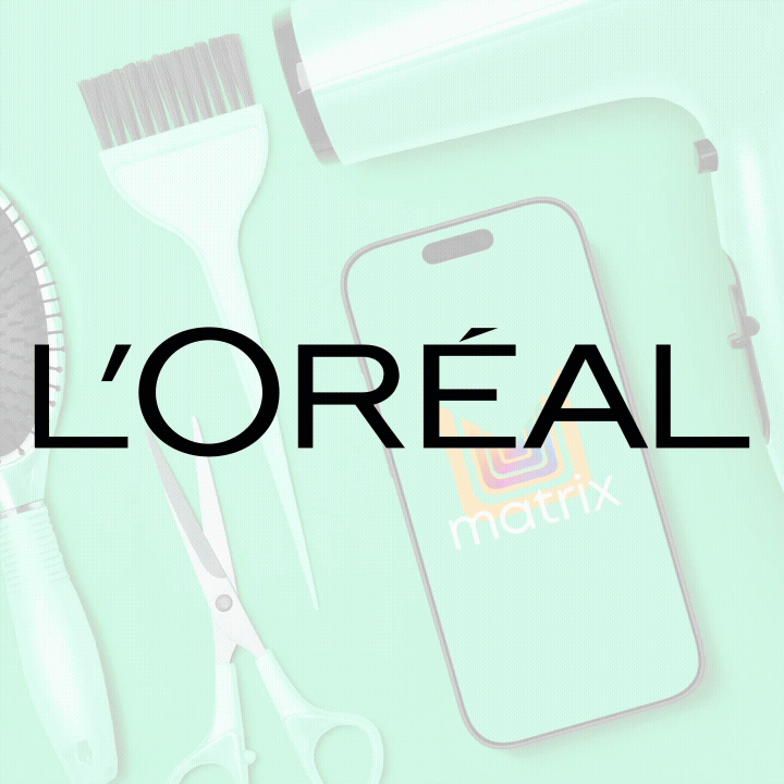 Hairbrush, hairdryer, scissors, and a smartphone with an L'Oréal logo on its screen.