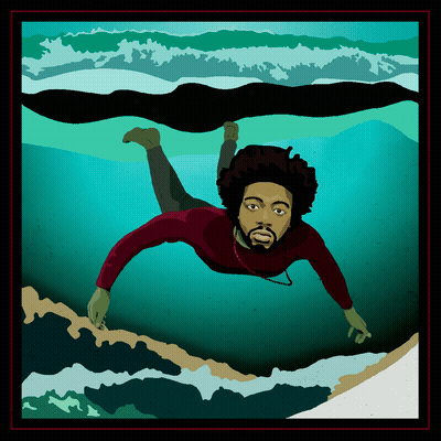 A person with curly hair and a beard swimming underwater in the ocean, facing forward.