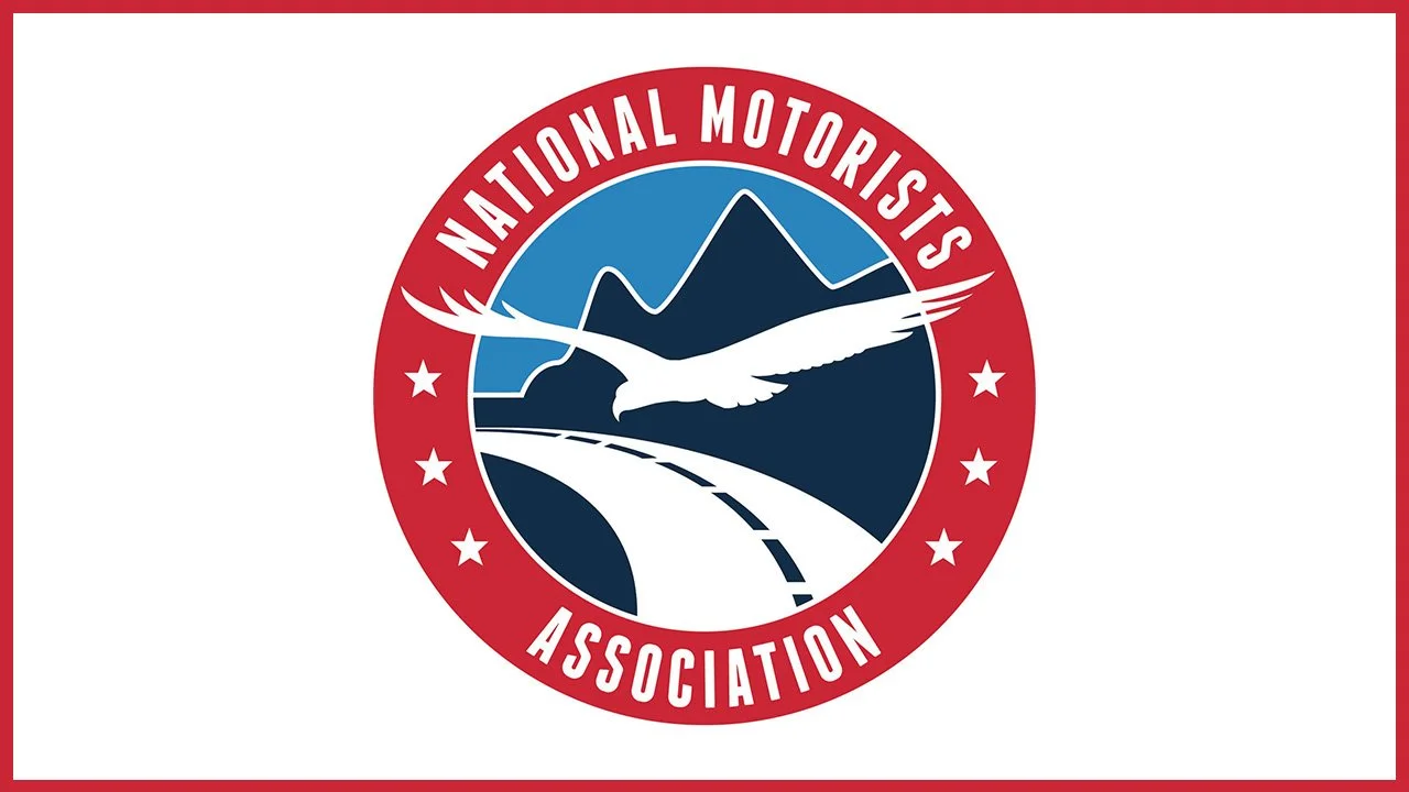 Logo of the National Motorists Association featuring a mountain, road, and flying bird in a circular design with red, white, and blue colors.