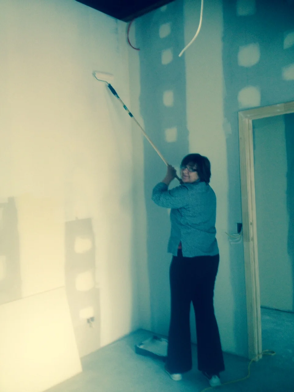 Judy adding the first undercoat to our walls