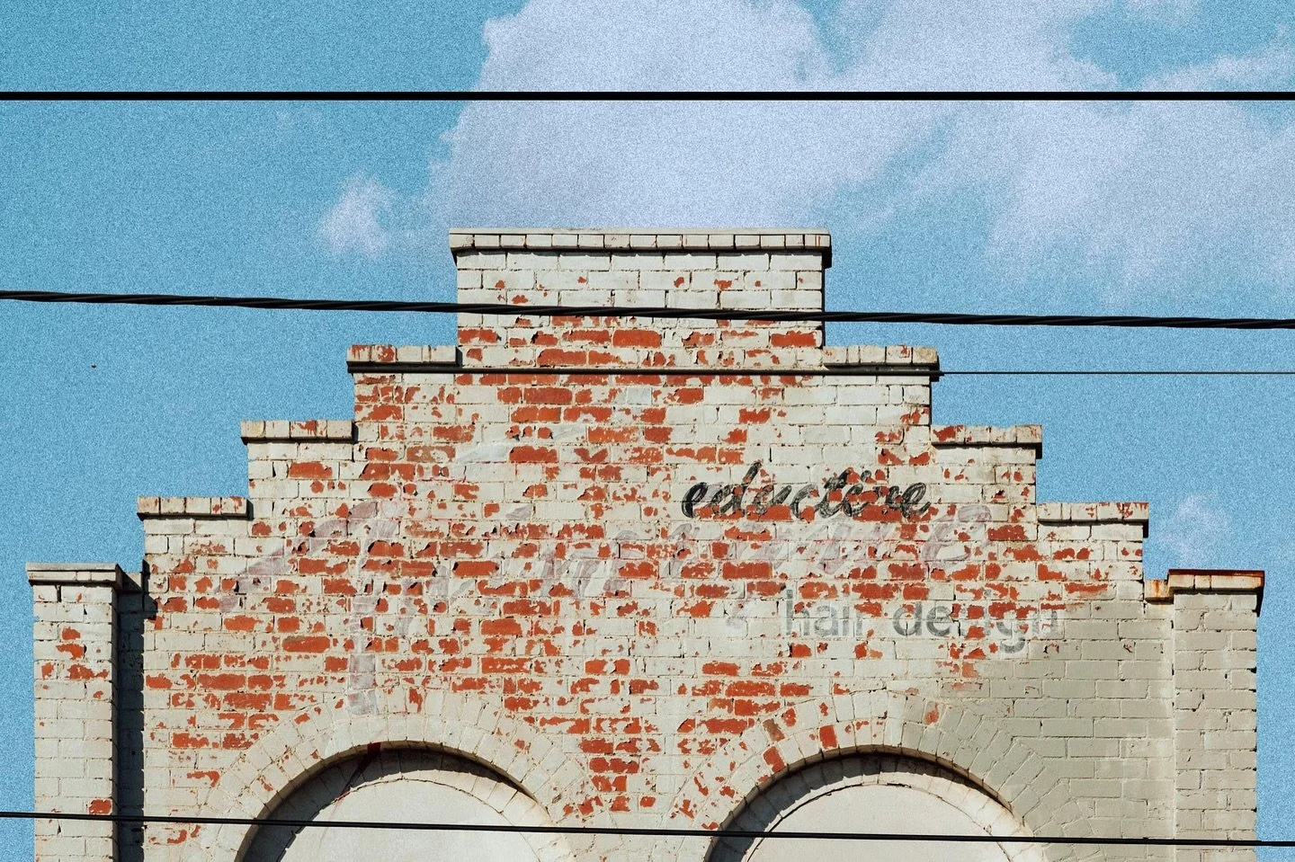 Faded signs and brickwork in the heart of Rathdowne St. 

A ghost sign for &ldquo;Eductorie Hair Design&rdquo; emerges from the facade, telling a quiet story against the Melbourne sky.

#melbournearchitecture #facade #oldsign #melbournephotographer #