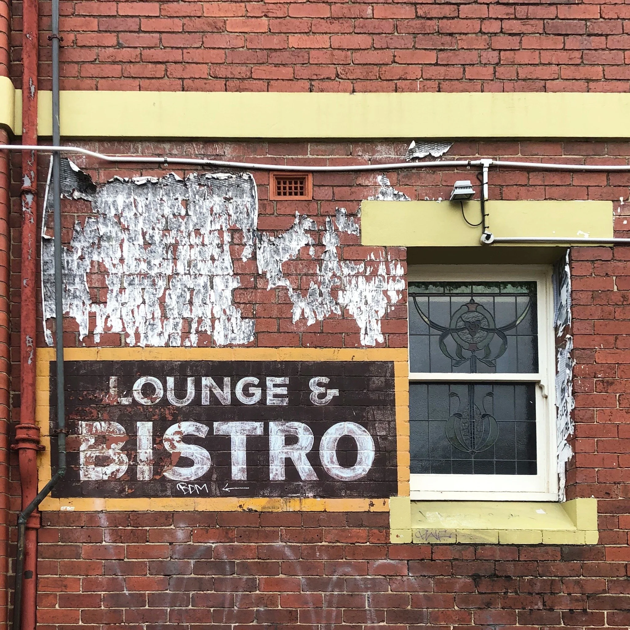 Lounge &amp; Bistro &mdash; what&rsquo;s left of it.

Fading layers, quiet character, and a touch of the north&rsquo;s grit.

 #MelbourneStreets #InnerNorth #MelbournePhotography #GhostSigns #OldSign #UrbanPhotography #HiddenNorth #Melbournephotograp