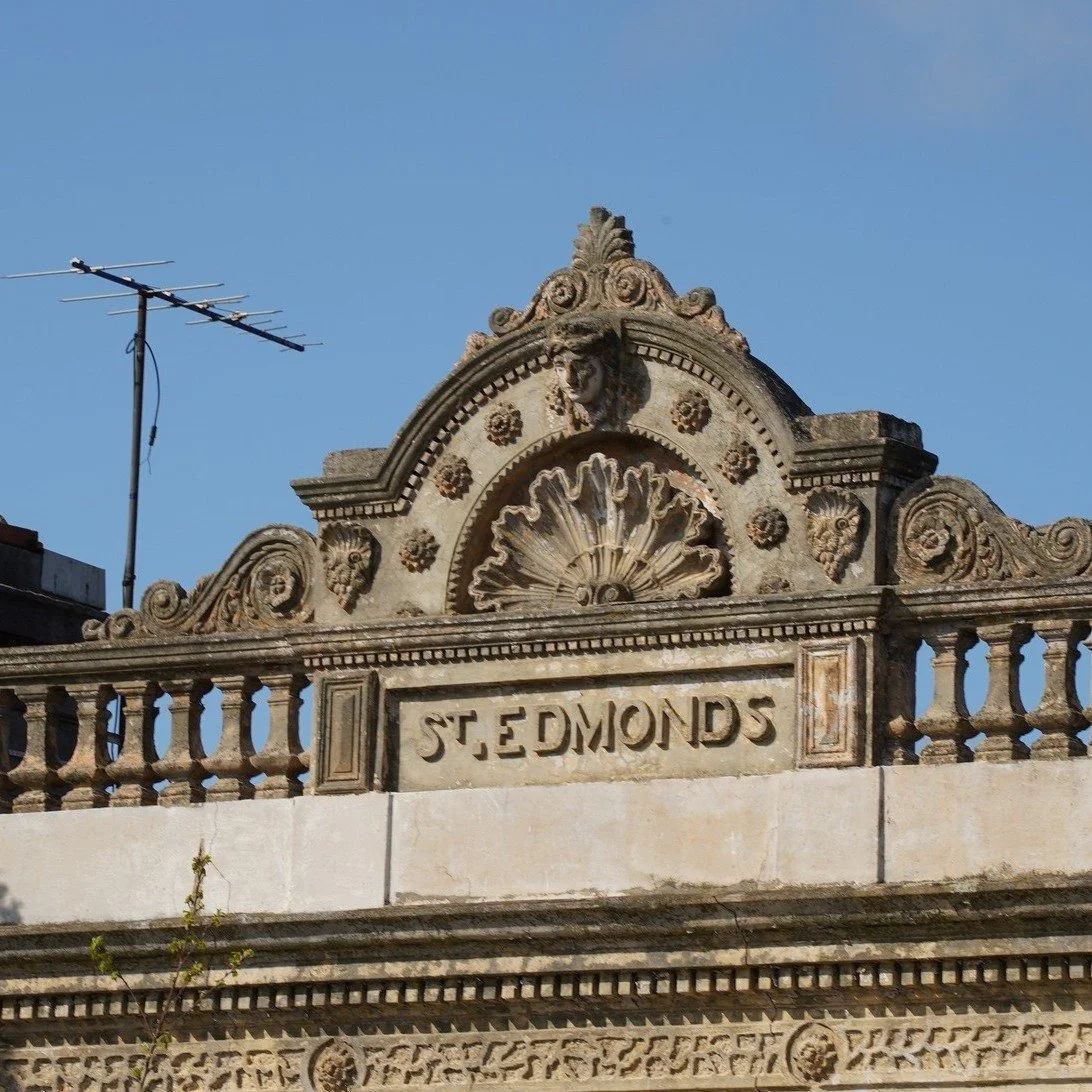 Upper fa&ccedil;ade of St Edmunds, North Carlton.

Decorative balustrades, carved stonework, and a name set into the parapet &mdash; details that often go unnoticed at street level. Buildings like this form the quiet architectural layer of the inner 