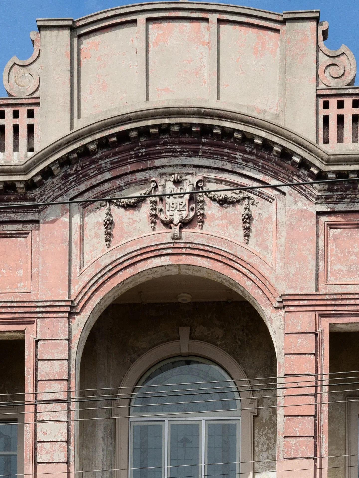 1912 etched into the facade &mdash; but do you know this building?

Faded pink render, ornate scrolls, that arched window sitting quietly beneath a century of weather.
One of the Inner North&rsquo;s old theatres&hellip; still holding its presence.

C