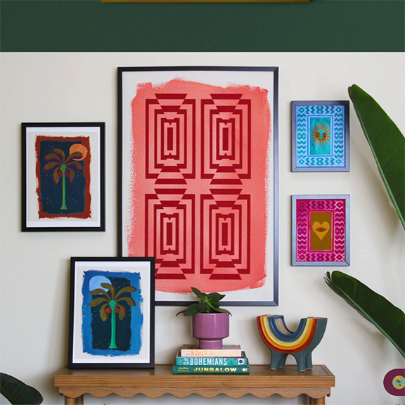 prints on a wall and decor by jungalow