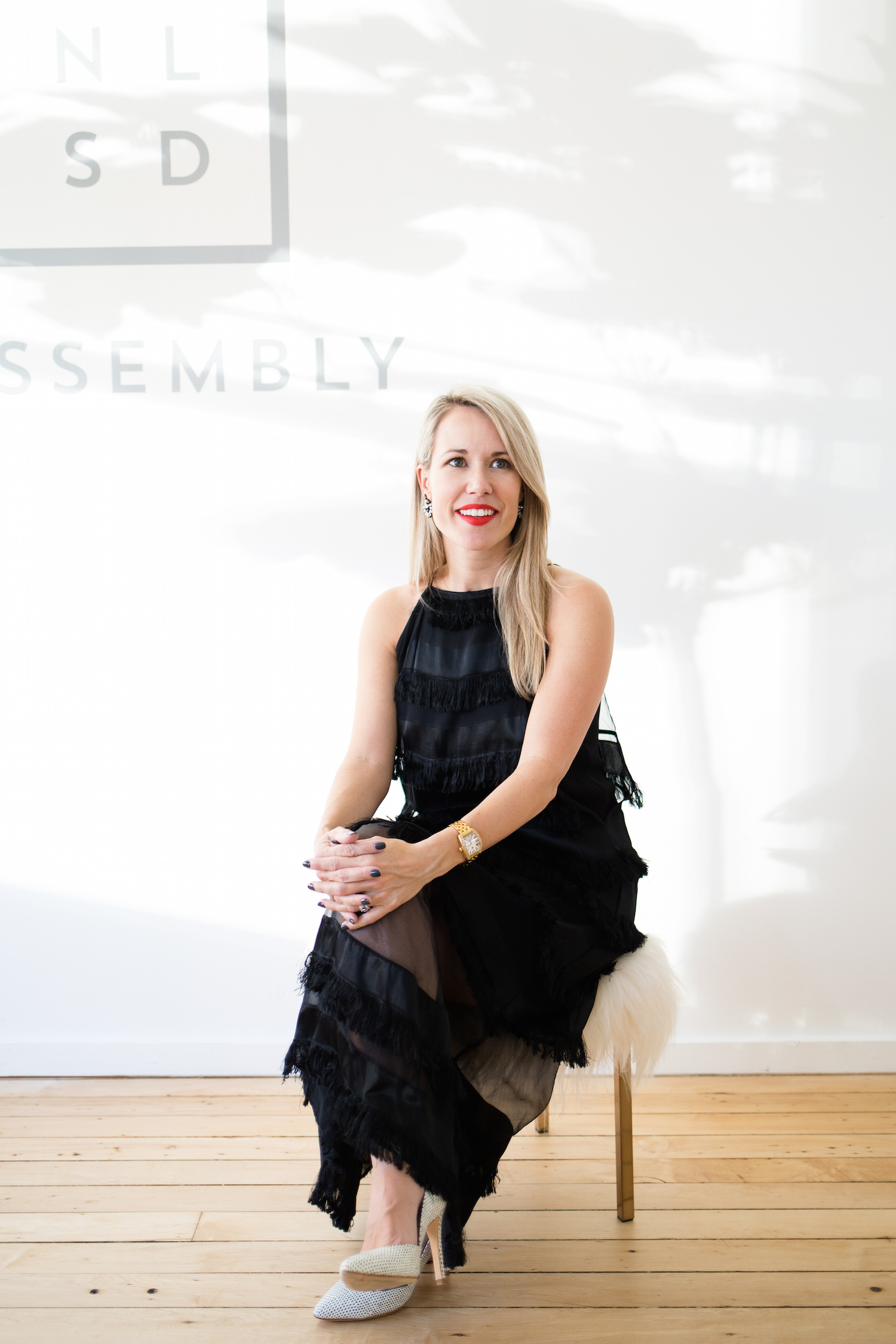 "Here I'm wearing the black satin fringe midi length Turner Dress ."