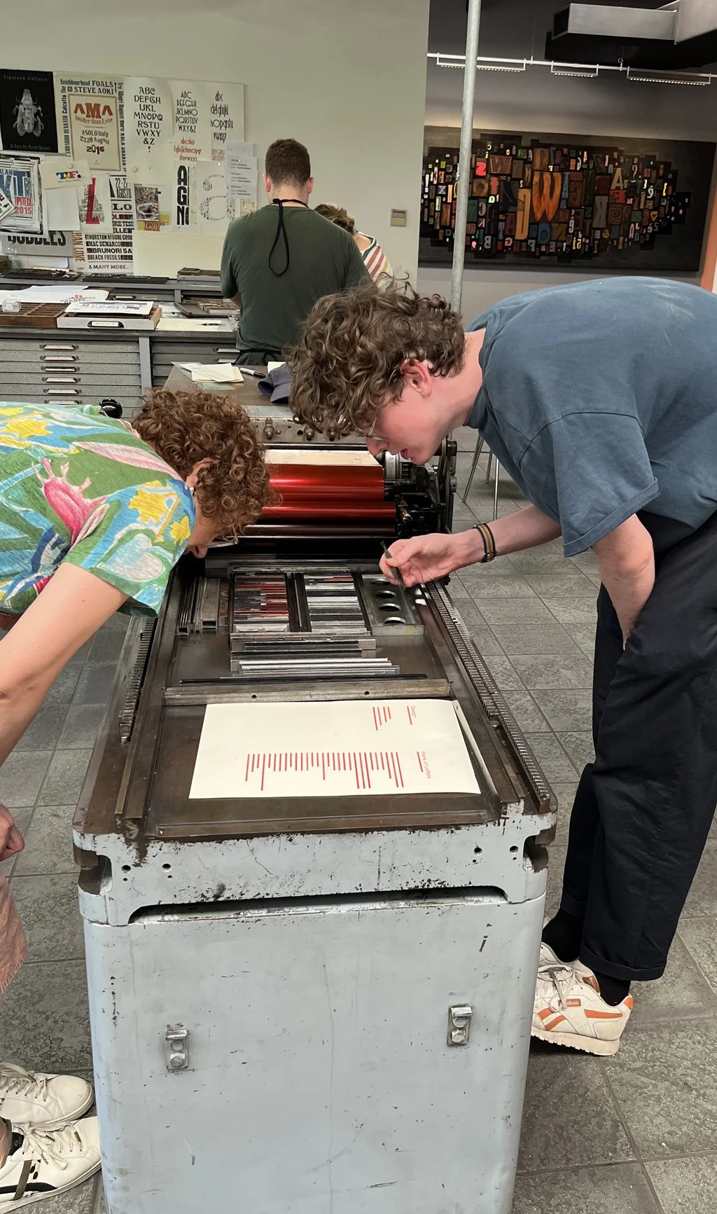 Susan-and-Fred-adjusting-type-on-press-lores.jpg