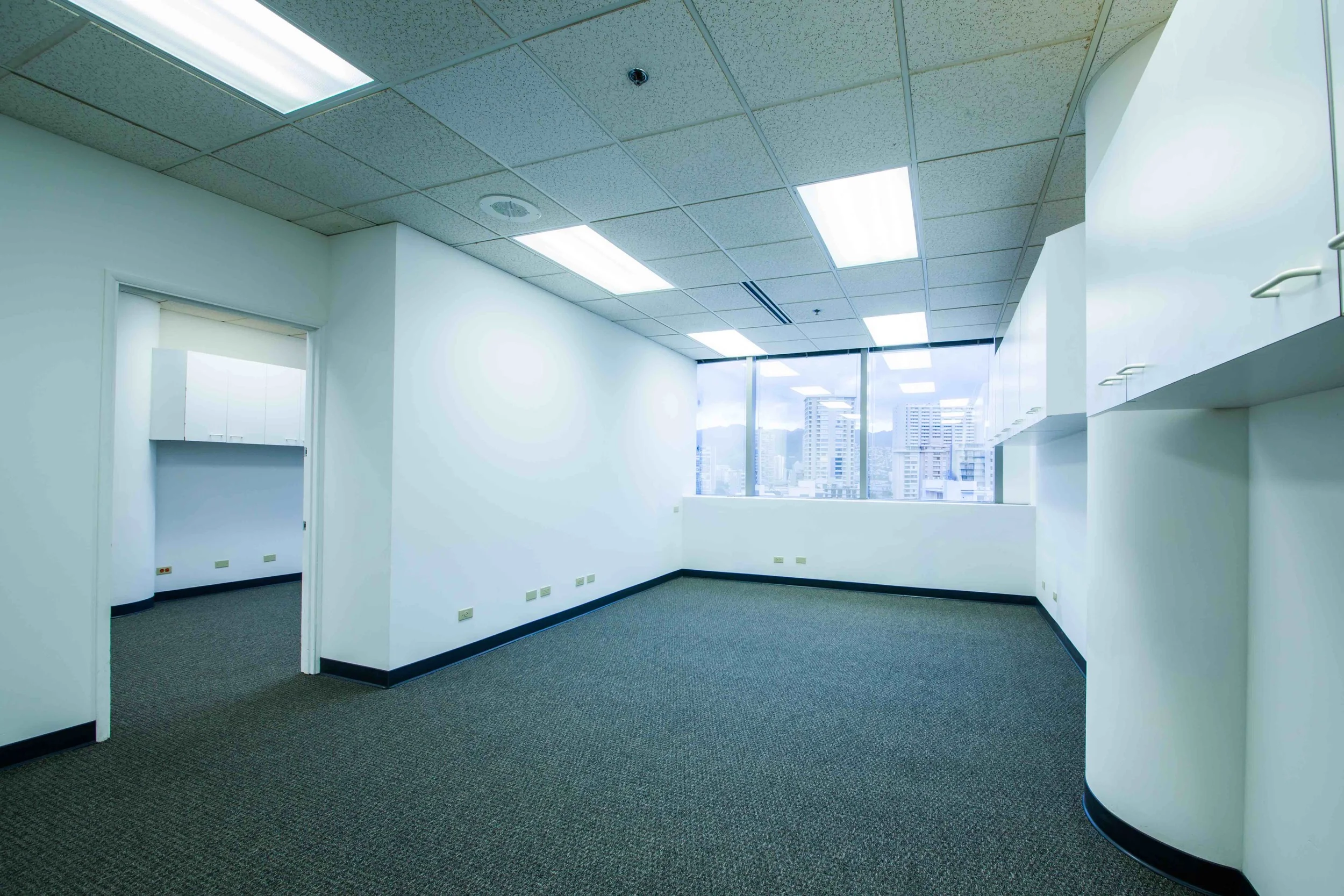 Suite is divided into two parts with an interior connecting door for flexible configuration. Each area of the office has an independent hallway door for separate entrances into the suite. Wall to wall window views of Kalakaua Avenue.