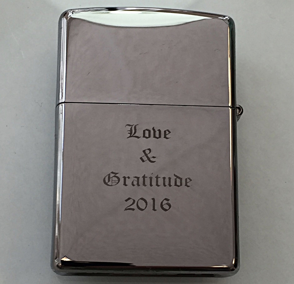 lighter hand engraved with lettering
