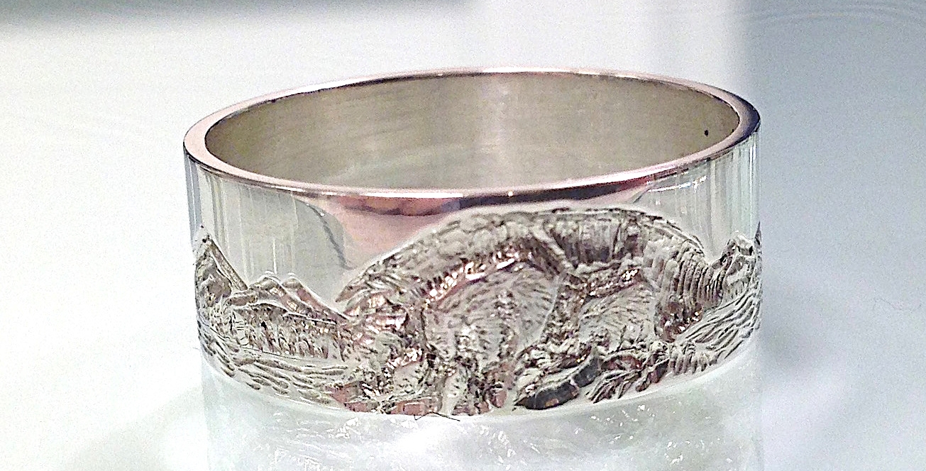 hand engraved gold ring with mountain scene and grizzly fishing
