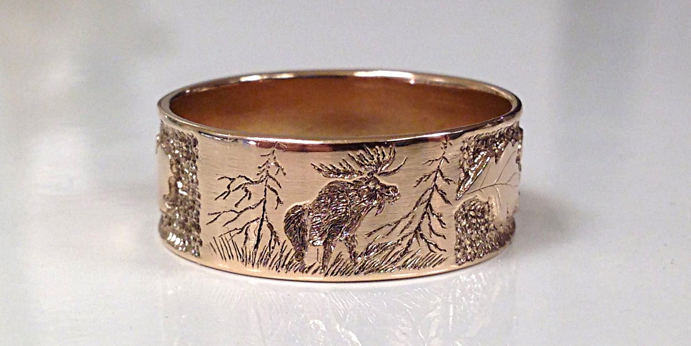 hand engraved ring with moose and wild scene 