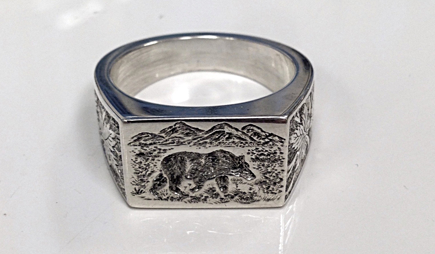 hand engraved ring with grizzly bear and maple leaf design 