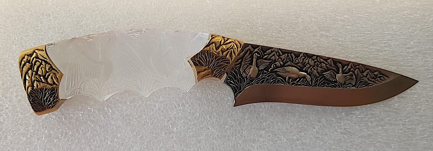 knive hand engraved blade and handle combination of brass and crystal hand engraved with geese and mountains .jpg