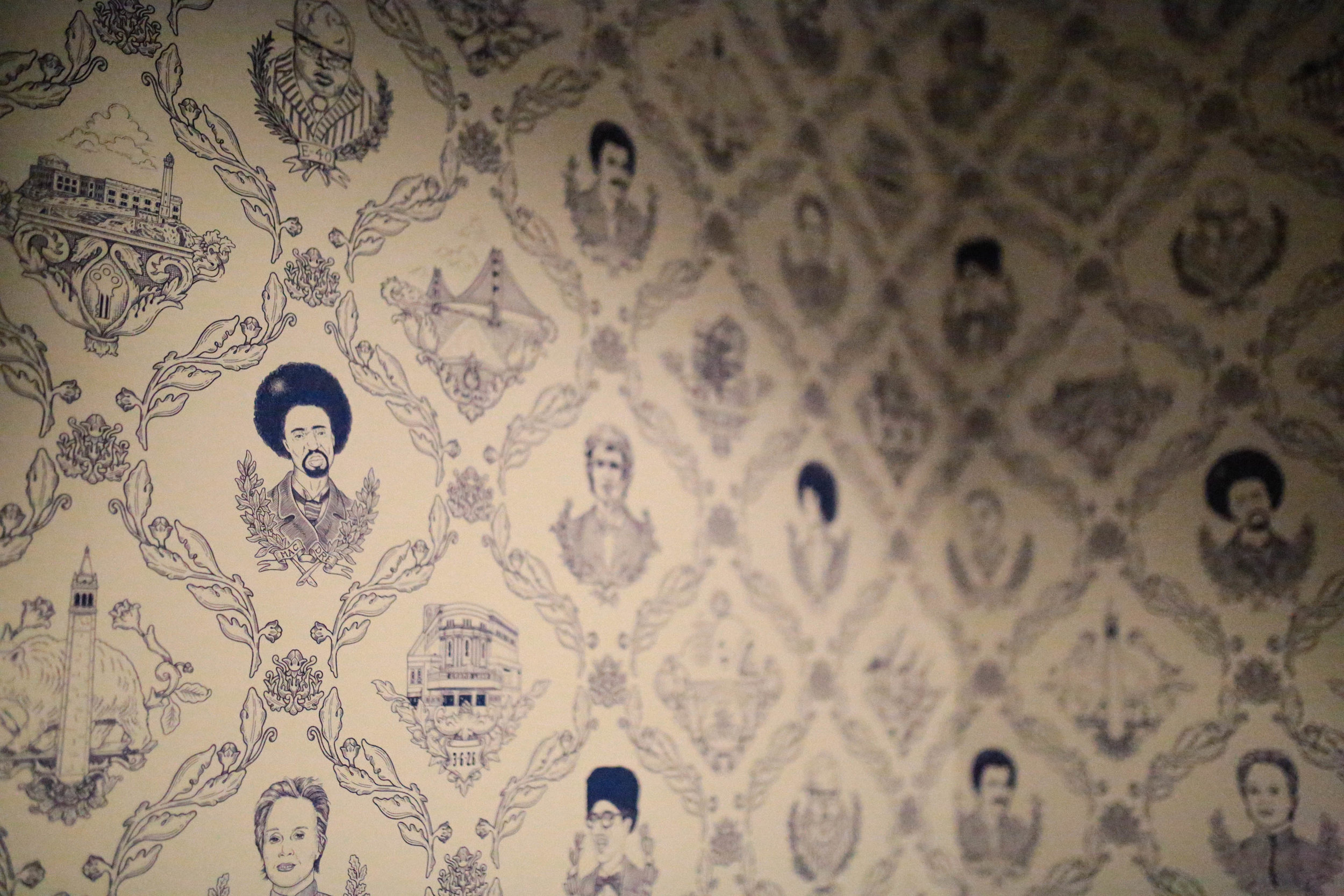 Illustrated wall mural featuring portraits of historical figures with floral and decorative patterns.