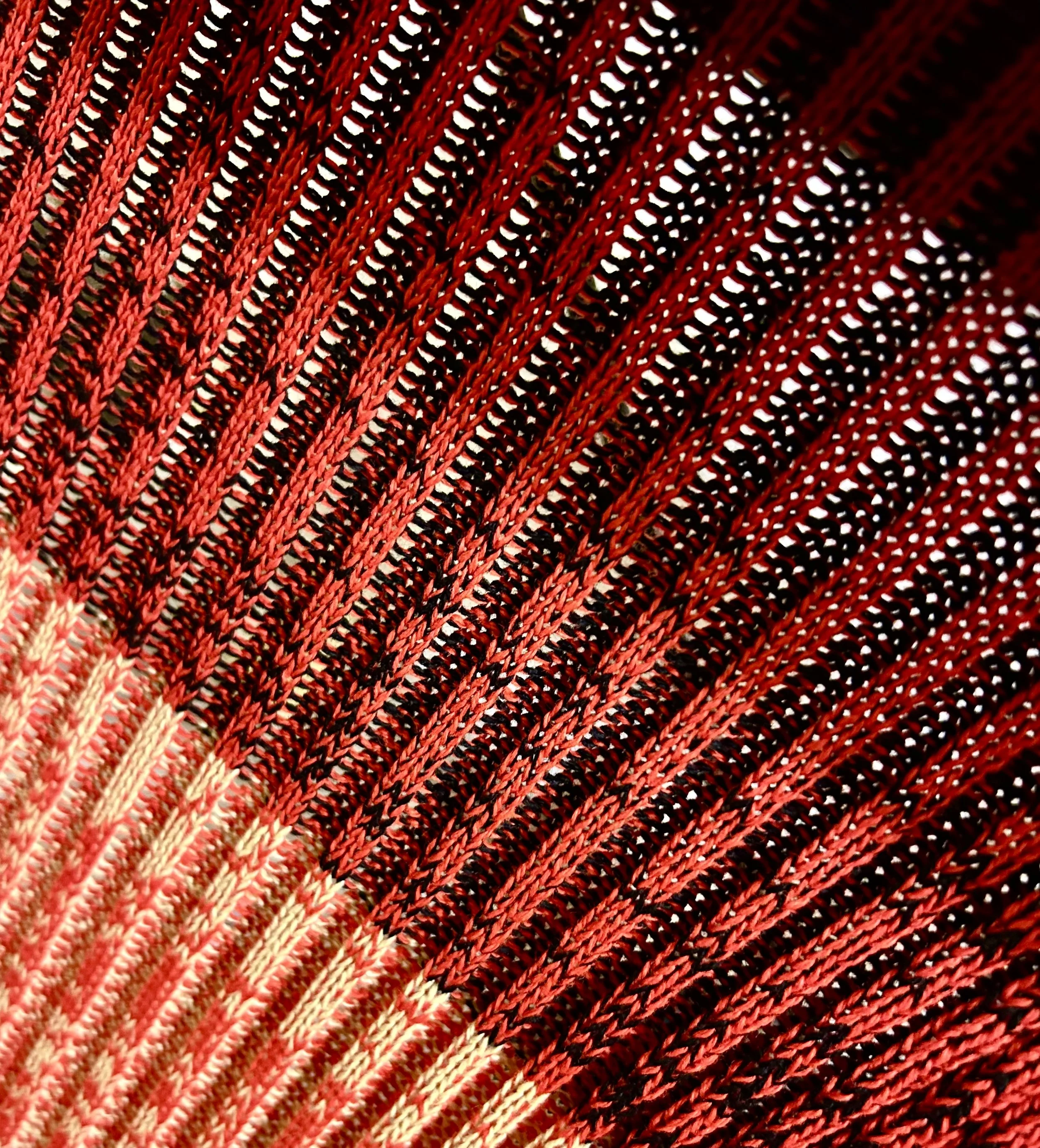 Close-up of a Breton Rib, multicoloured scarf on a knitting machine.
