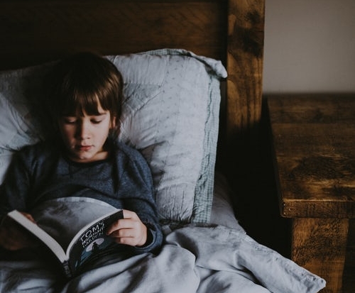 boy reading in bed.jpeg