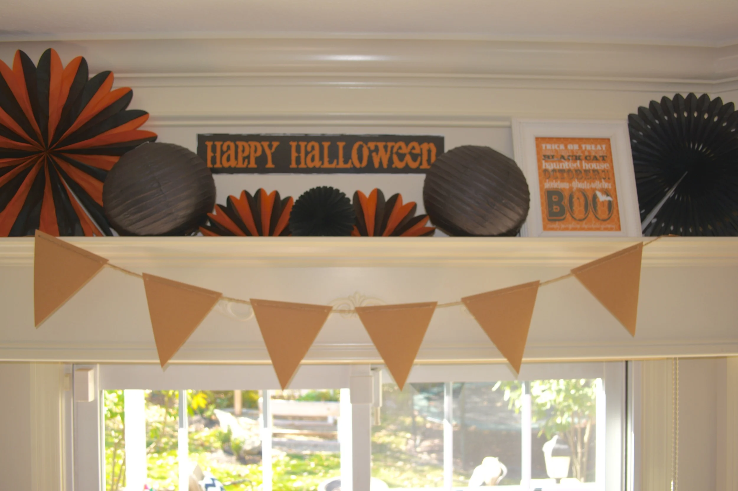 Above our glass door to the back yard, Lance built a large window cornice that I often decorate for holidays and birthdays.